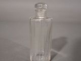 a small glass bottle with a clear lid on a table