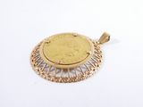 an image of a gold coin pendant on a white surface