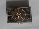 a picture of a decorative box with a compass on it