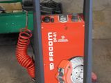 a red machine that is sitting in the garage