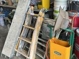 a pile of assorted items and tools in a garage