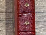 a red book sitting on top of a wooden table