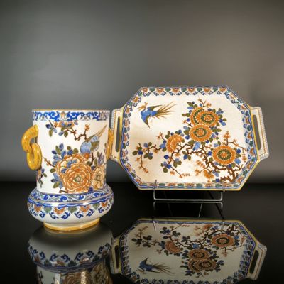 two pieces of porcelain are sitting on a black surface