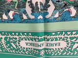 a green and white scarf with a picture of elephants on it