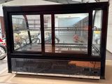 a display case with a lot of food inside of it