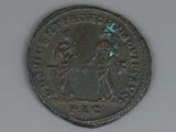 an old coin with the image of a woman and a man on it