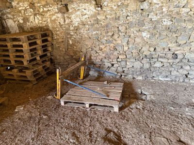a wooden pallet in the middle of a dirty room