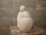 a white sculpture sitting on top of a wooden table