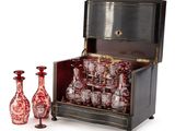 bottles and vases are sitting in front of an antique chest