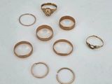 a lot of gold rings on a white surface