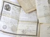 several old papers are stacked on top of each other on a table