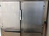 two stainless steel refrigerators that are in a kitchen