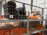 many orange bins on the shelves in the warehouse