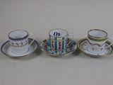 three cups and saucers are sitting side by side on a table