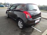 a small black car that is parked in a parking lot
