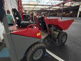 an image of a red and gray tractor parked in a parking lot