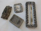 several pieces of jewelry are laying out on a white surface