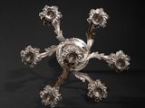 an antique silver plate with a flower design on it