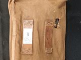 a brown bag with a tag on it sitting on a black surface