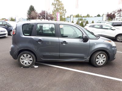 a small grey car parked in a parking lot