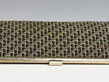 an image of a gold and black business card case on a white surface