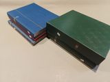 three books are stacked on top of each other on a table