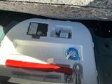 a small red object in the center of the compartment of a car