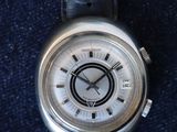 an image of a close up of a wrist watch on a blue surface