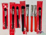 six knives are lined up in a row on a white surface