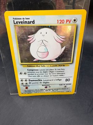 a pokemon card in a plastic box on a table