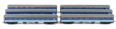 two blue and silver train cars sitting side by side