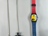 a watch and a lanyard on a white surface