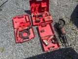 a red box with tools on the ground next to it