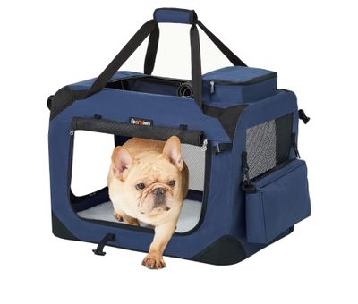 a small dog laying in a blue dog carrier