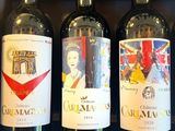 several bottles of wine are lined up on a shelf in a store