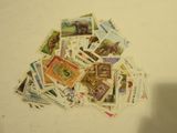 a pile of postage stamps on a white surface