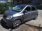 a small grey car parked on the side of the street