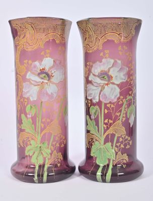 pair of vases with purple and gold designs on them on a white surface
