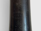 a black vase with a gold rim sitting on a table
