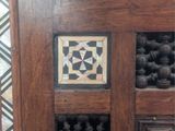 a close up of a wooden door with a tile design on it