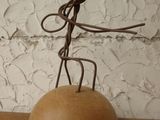 a metal sculpture of a man on a rock on a table