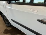 a white car with a sticker on the side of it ' s door