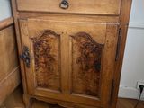 a wooden cabinet with a picture on top of it