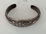 a silver bracelet with a braid design on it