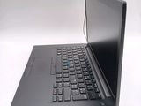 a black laptop with a blue keyboard on a white surface