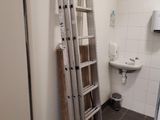 a ladder leaning up against a wall in a bathroom