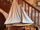 a small sailboat on a table in front of a staircase