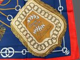 a blue and red scarf with a gold design on it