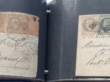 an open book with a lot of old stamps on it