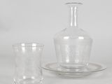 a glass vase and a glass cup on a table